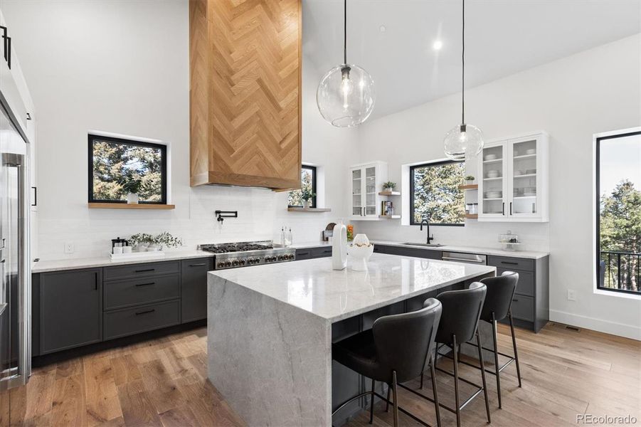 Chef's dream kitchen features stunning waterfall Tahiti quartzite island, thoughtful storage solutions, professional JennAir appliances, pot filler & more Chef's dream kitchen features stunning waterfall Tahiti quartzite island, thoughtful storage solutions, professional JennAir appliances, pot filler & more