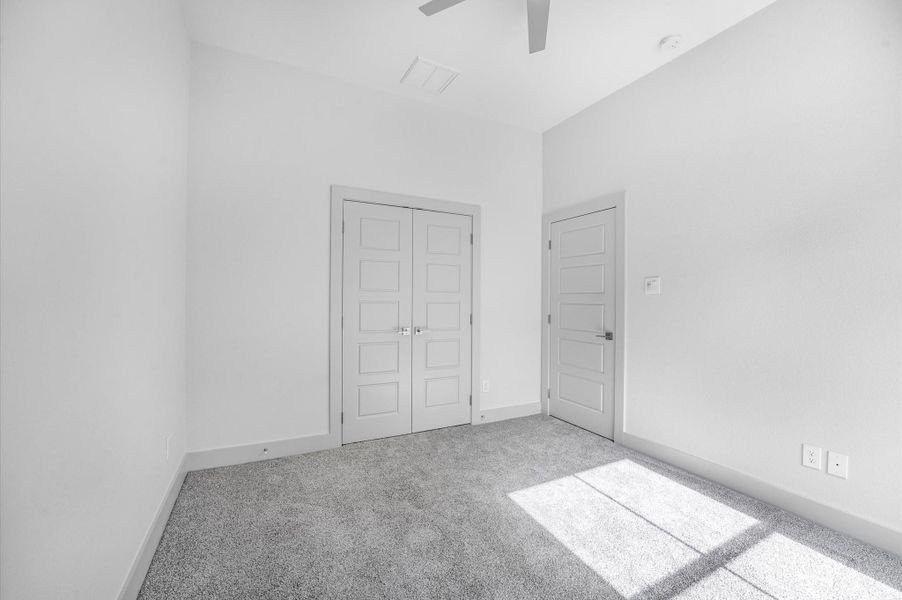 This room features neutral-toned walls and carpet, with ample natural light. It includes a double-door closet and a single-door entry, offering a clean and versatile space suitable for a bedroom or office. This room features neutral-toned walls and carpet, with ample natural light. It includes a double-door closet and a single-door entry, offering a clean and versatile space suitable for a bedroom or office.
