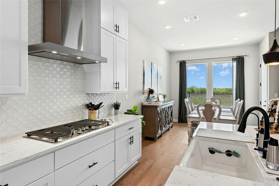 Kitchen with soft close white cabinets and light stone counters