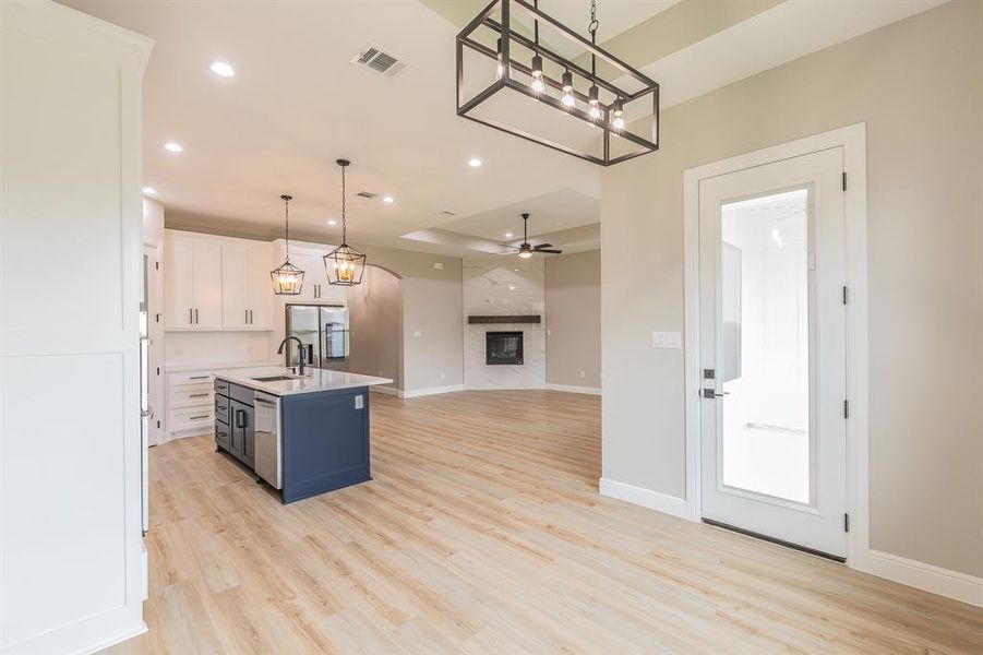 Kitchen featuring appliances with stainless steel finishes, open floor plan, a sink, a ceiling fan, and recessed lighting Kitchen featuring appliances with stainless steel finishes, open floor plan, a sink, a ceiling fan, and recessed lighting