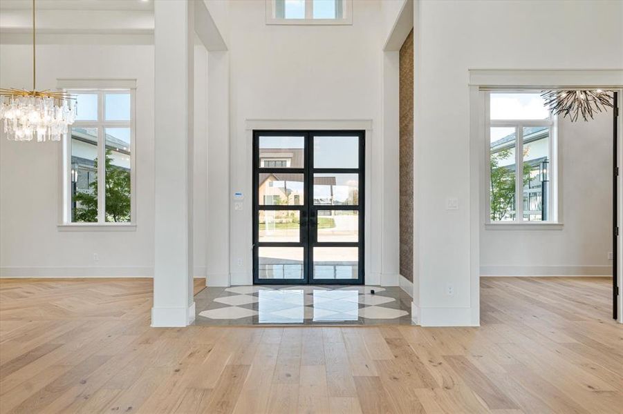 Foyer with a chandelier and wood-type flooring
