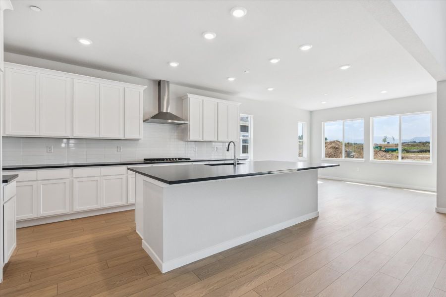A kitchen with white cabinets.