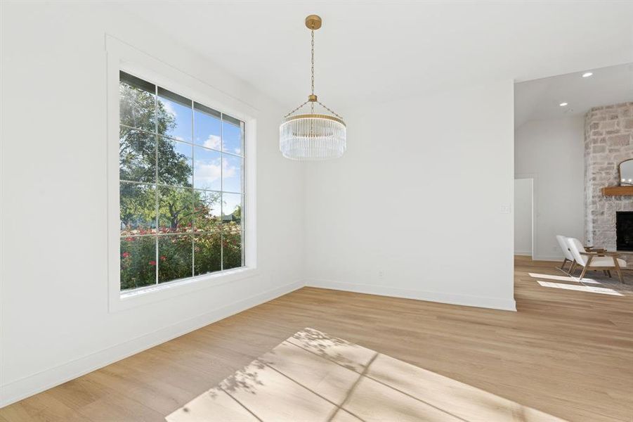 Lovely dining room with views of the backyard and the rose bushes just beyond the window.