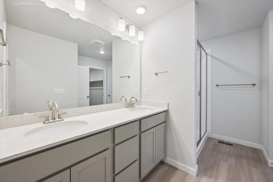 A bathroom with a large mirror. A bathroom with a large mirror.