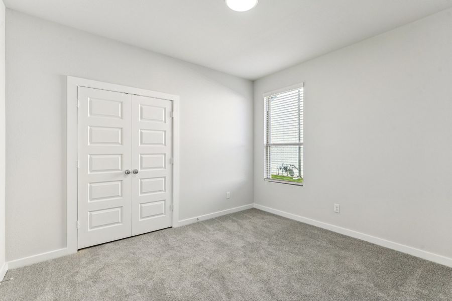 Bedroom in the Wimbledon home plan by Trophy Signature Homes – REPRESENTATIVE PHOTO