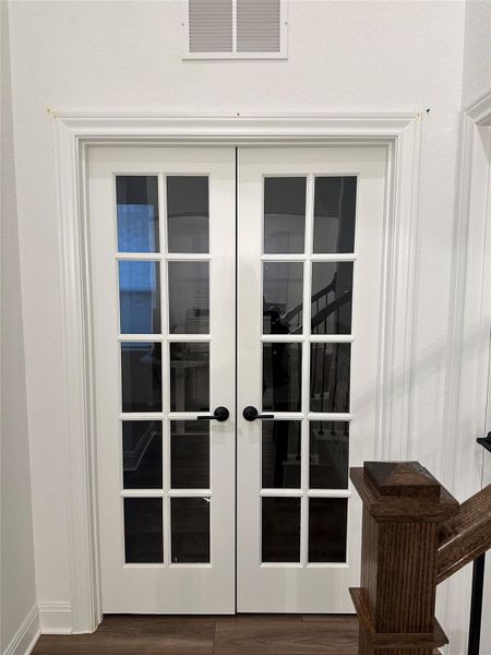 Double French doors with clear glass panes and matte black hardware Double French doors with clear glass panes and matte black hardware