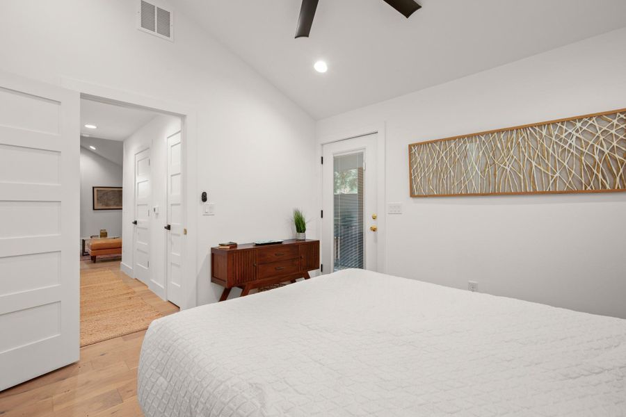 Bedroom featuring lofted ceiling, light wood finished floors, access to outside, recessed lighting, and a ceiling fan