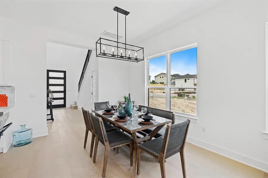 Dining room with ample spacing yet open floor plan connects kitchen island making for a great gathering area