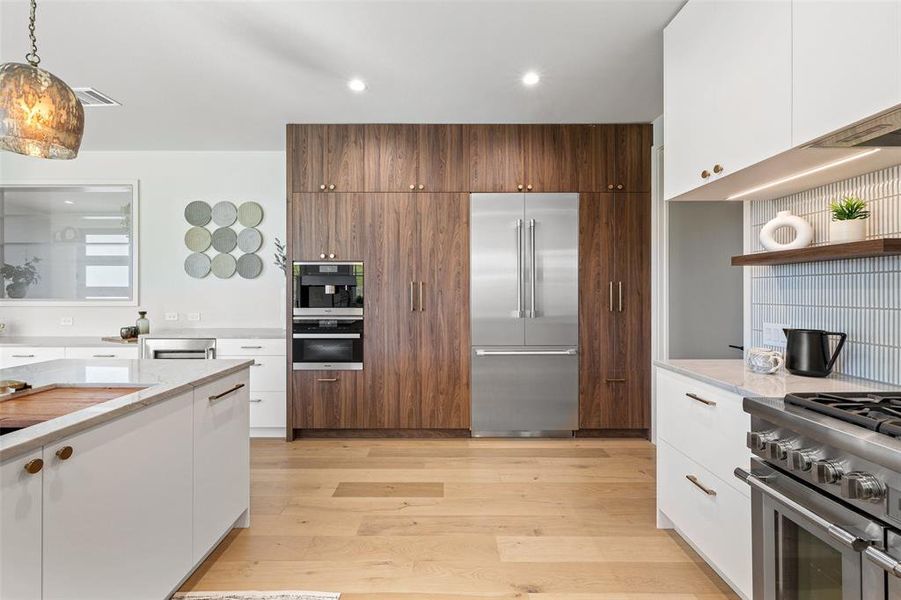 Modern design elements blend seamlessly in this kitchen, creating a visually stunning space that maximizes both style and functionality.