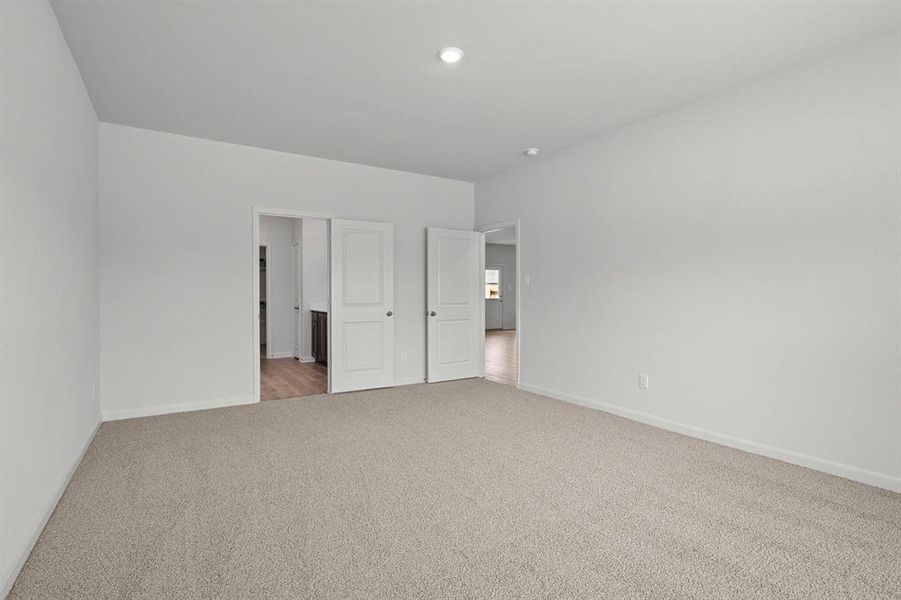 Unfurnished bedroom featuring carpet and ensuite bath