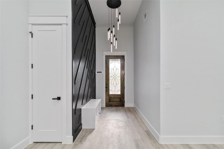 Entryway featuring a barn door and light wood finished floors