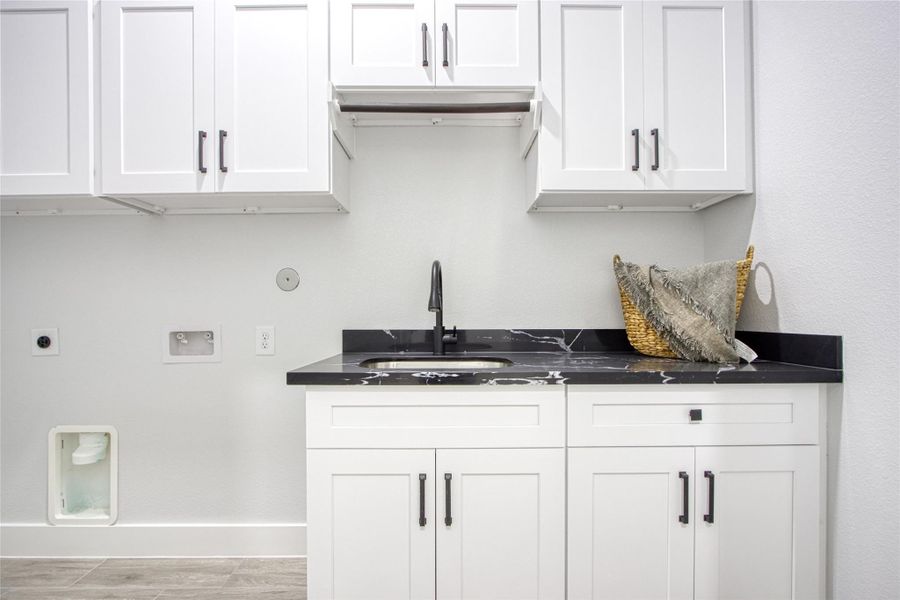 Spacious laundry room with lots of cabinets and sink. Spacious laundry room with lots of cabinets and sink.