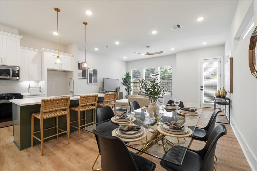 A seamless main level where defined spaces still feel connected. The designated dining area flows effortlessly into the kitchen and living room, all framed by large windows and elevated ceiling heights that keep the space open and bright. Welcome to Pech Landing! A seamless main level where defined spaces still feel connected. The designated dining area flows effortlessly into the kitchen and living room, all framed by large windows and elevated ceiling heights that keep the space open and bright. Welcome to Pech Landing!
