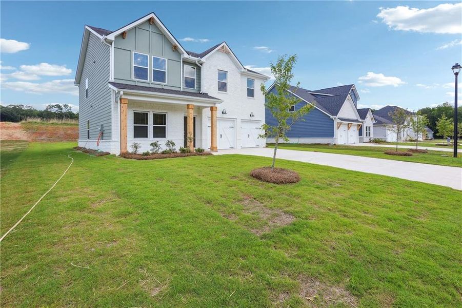 Front exterior of a new home in Conner Springs, Social Circle, GA, highlighting curb appeal (Image 20). Front exterior of a new home in Conner Springs, Social Circle, GA, highlighting curb appeal (Image 20).