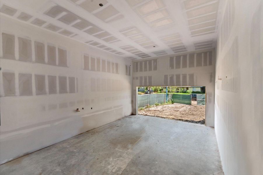 Insulated custom garage door with a vertical lift for additional storage.