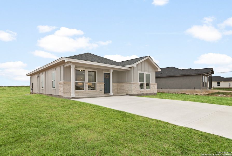 Front exterior of a new home in , La Vernia, TX, highlighting curb appeal (Image 18).