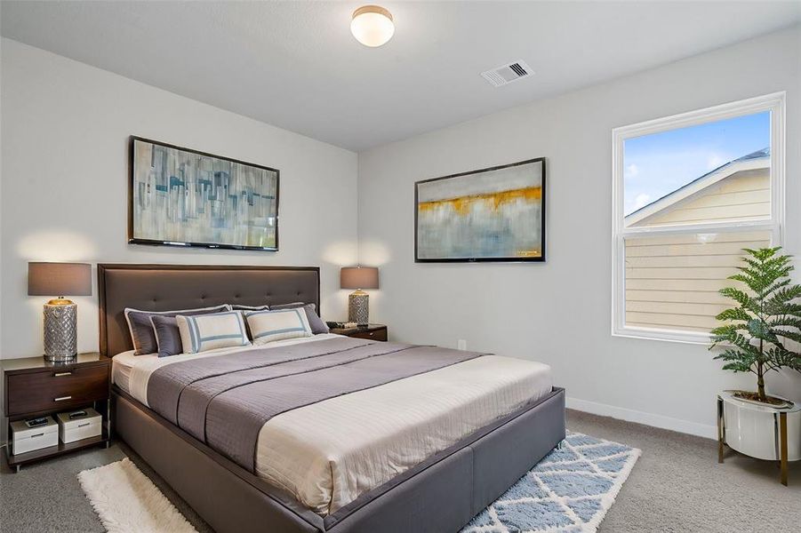 This secondary bedroom features custom paint, plush carpet, and a large window with privacy blinds!