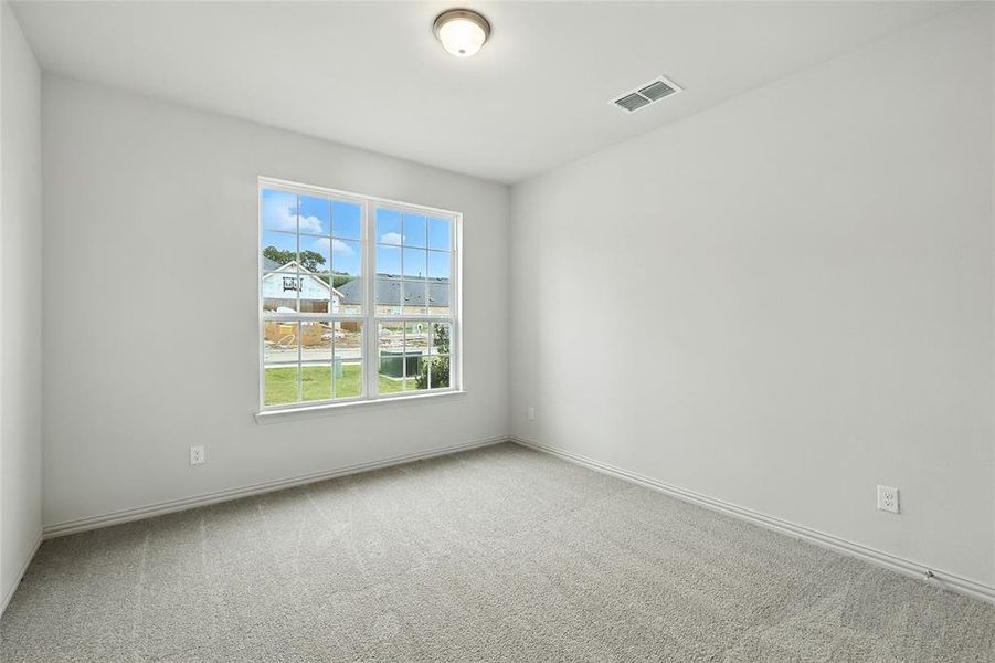 Unfurnished room featuring light carpet and baseboards