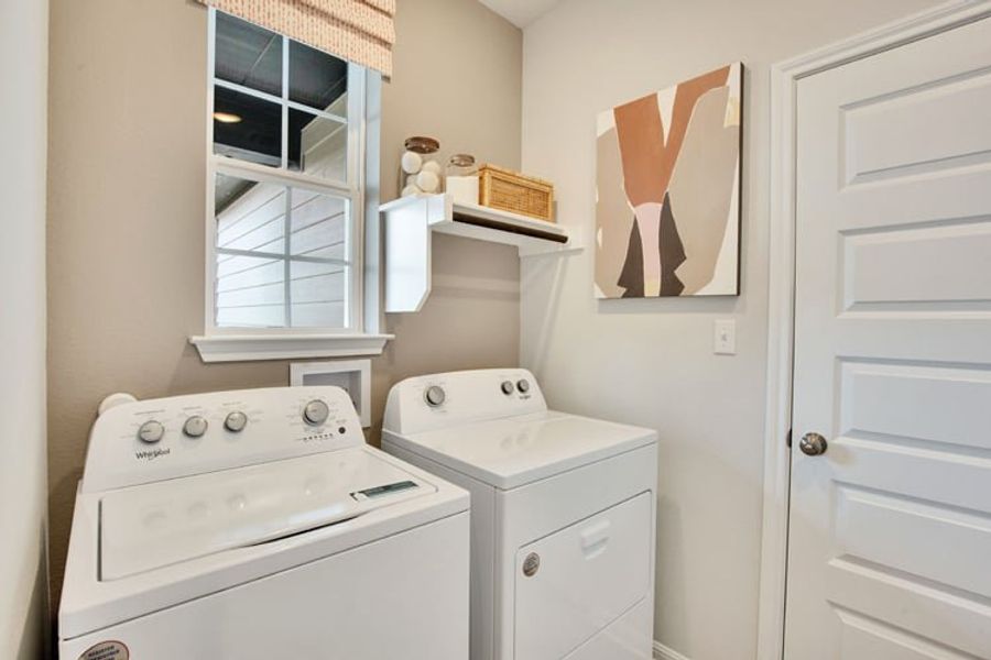 A laundry room with a washer and dryer. A laundry room with a washer and dryer.