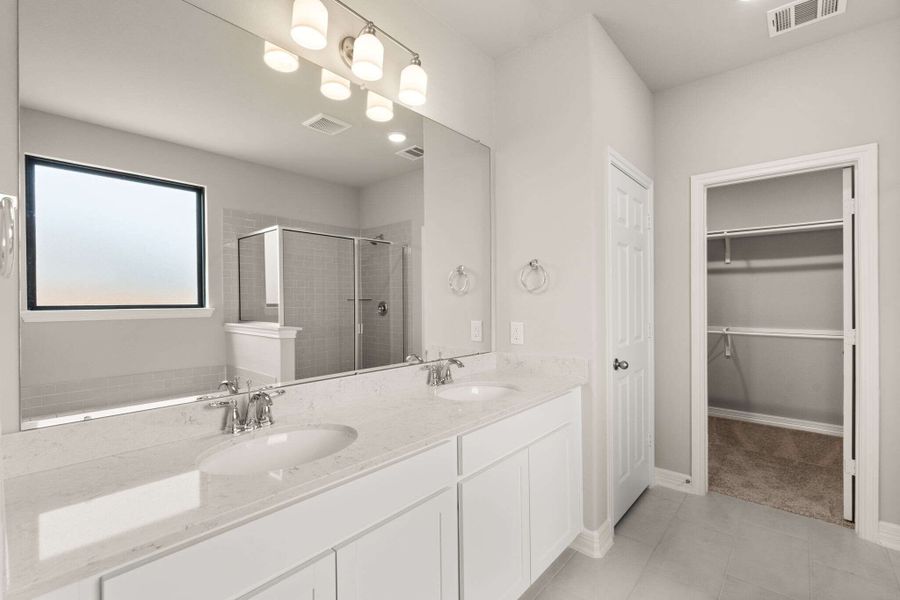 An additional view of the bath and double sink vanity.