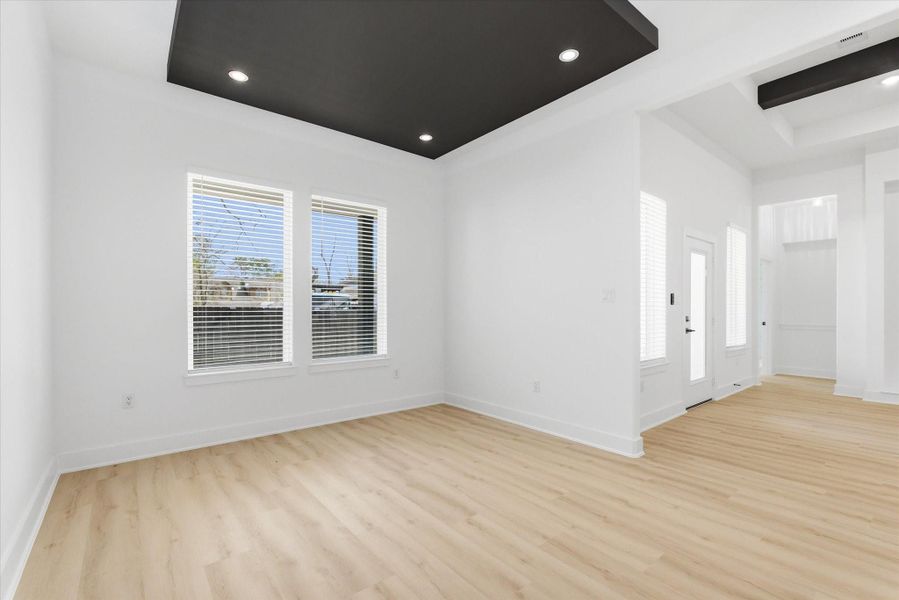 The impressive dining area features a floating ceiling detail and is conveniently located adjacent to the chef’s kitchen.