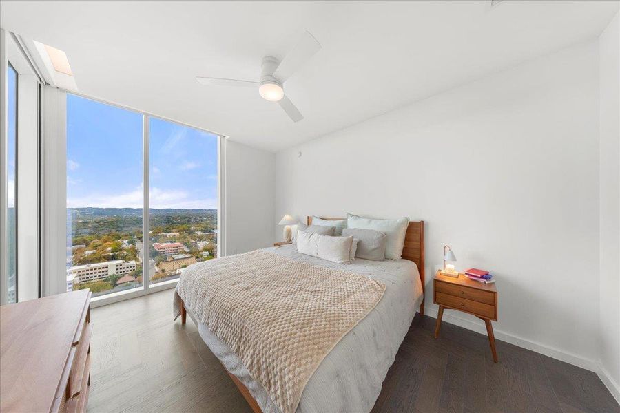 Light-filled primary bedroom with panoramic views and a connected ensuite bath, creating a serene and modern retreat.