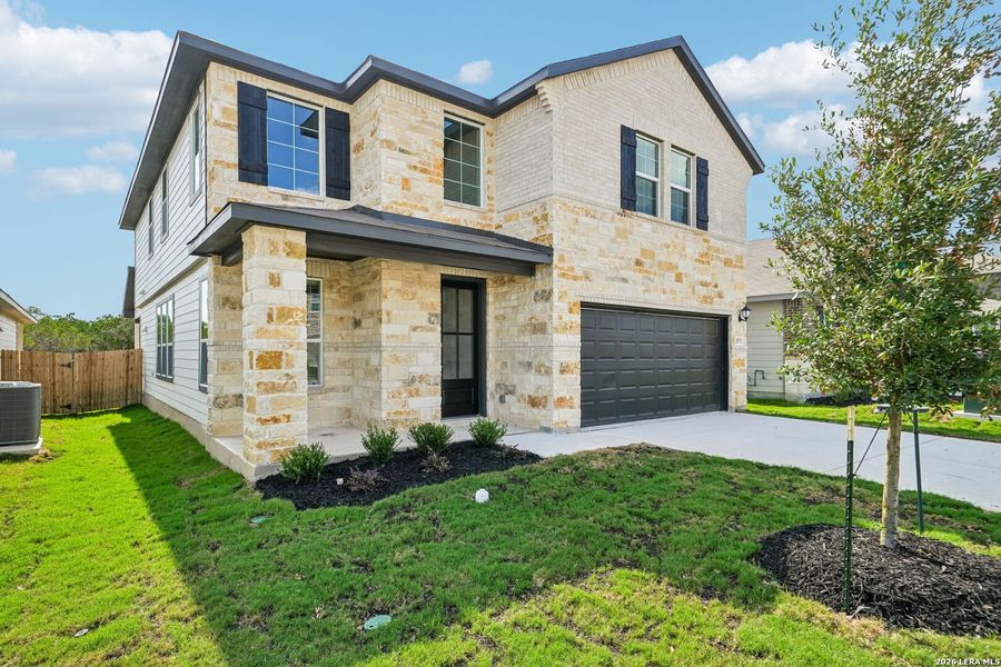 Front exterior of a new home in Thomas Pond, San Antonio, TX, highlighting curb appeal (Image 2). Front exterior of a new home in Thomas Pond, San Antonio, TX, highlighting curb appeal (Image 2).