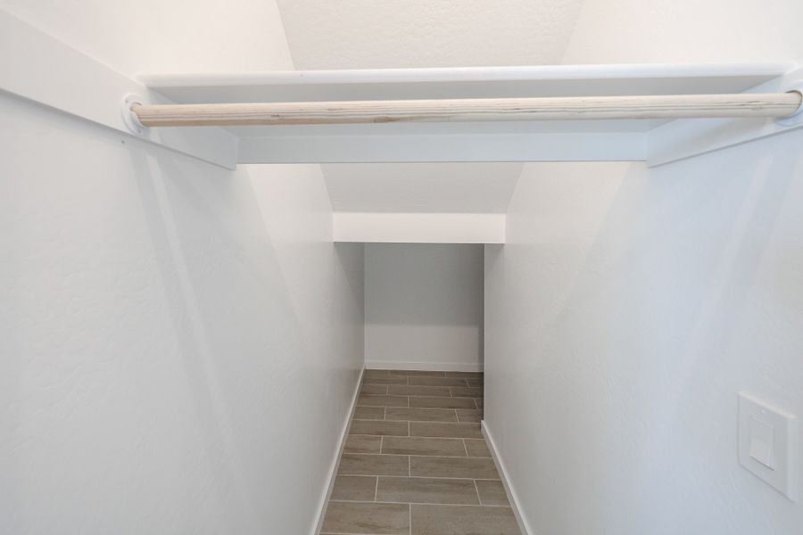 A white shelf with a white wall.