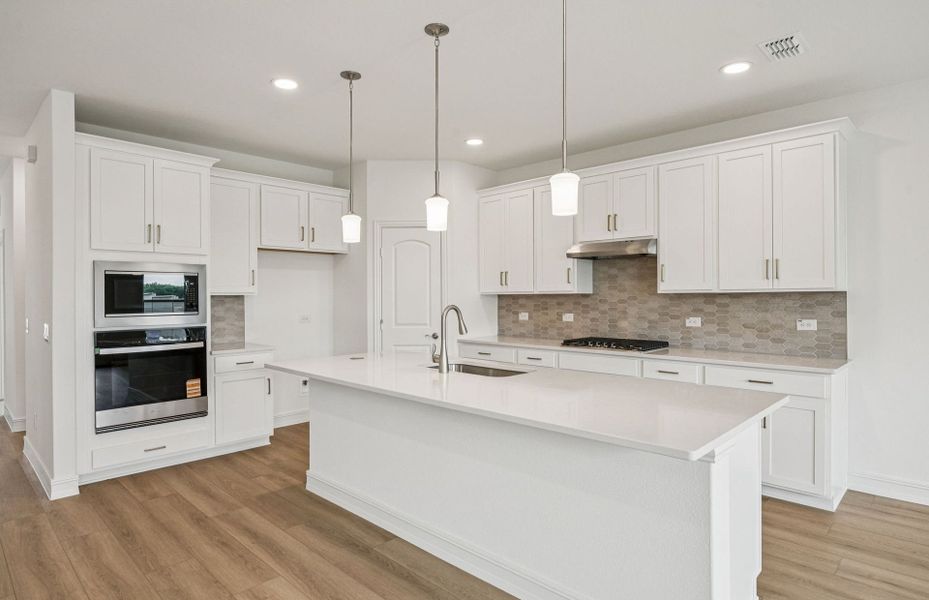 Bright kitchen with an expansive center island perfect for gatherings  *Real home pictured