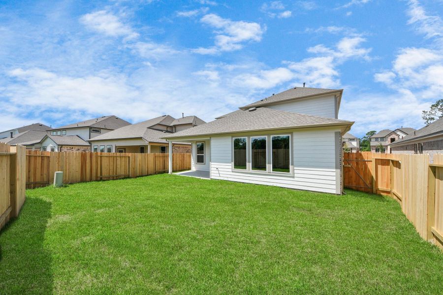 Explore the expansive backyard with its inviting covered patio—a perfect blend of space for the kids to play and adults to unwind. Ideal for creating your outdoor oasis, this backyard accommodates patio furniture, a BBQ pit, and endless possibilities for leisure and entertainment. Sample photo of completed home with similar floor plan. Actual colors and selections may vary.