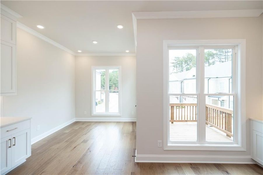 Entryway with crown molding and light wood-type flooring