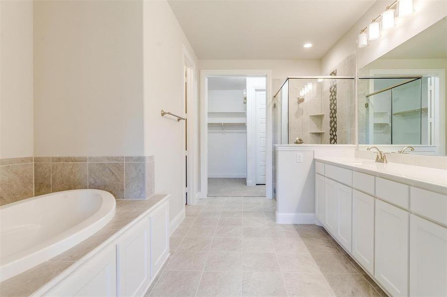 Bathroom with vanity, independent shower and bath, and tile patterned floors