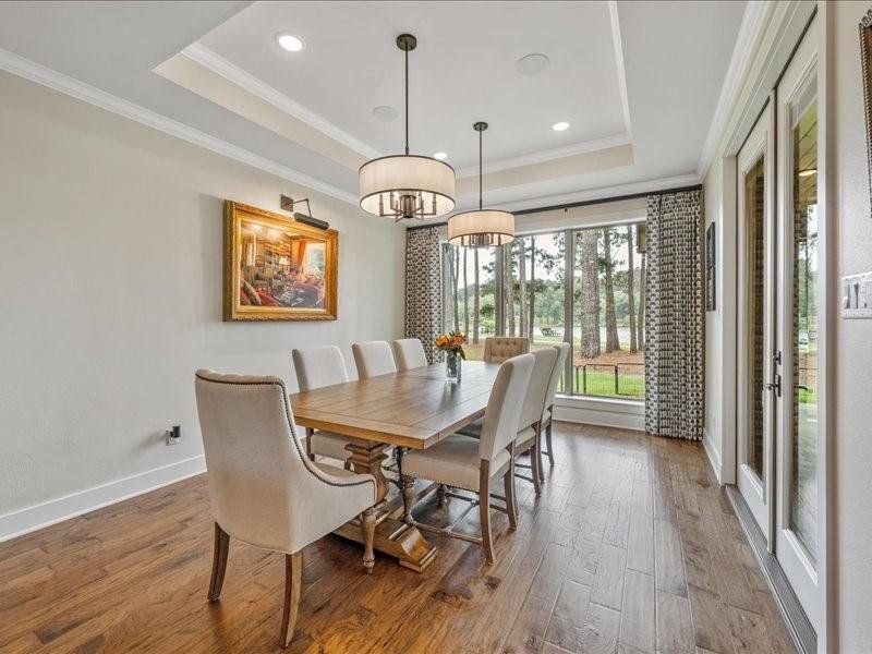 Formal dining area with custom draperies and tray ceiling.  Double doors that can be open on a cool evening.