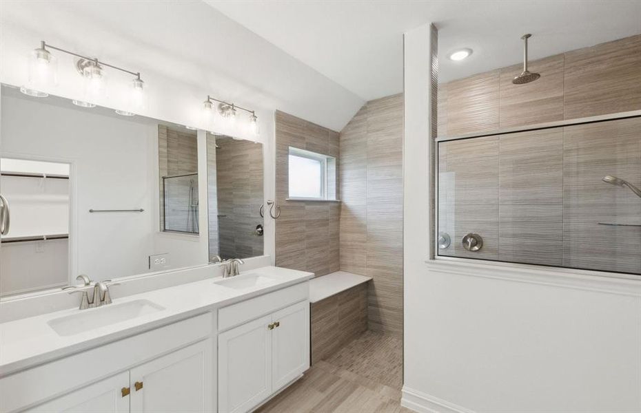 Spacious owner's bathroom with dual vanity and large shower *real home pictured