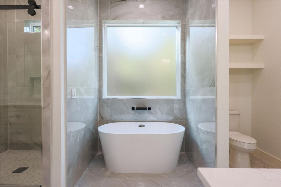 Upgraded luxury master bathroom with a stand up shower and freestanding tub. Upgraded luxury master bathroom with a stand up shower and freestanding tub.