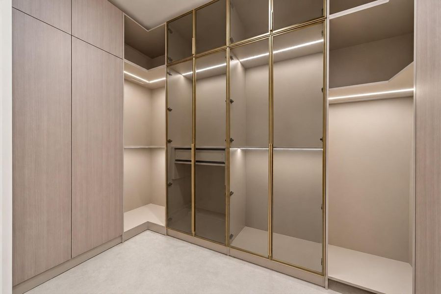Huge primary his and hers closets with smart built in closets featuring LED lighting.