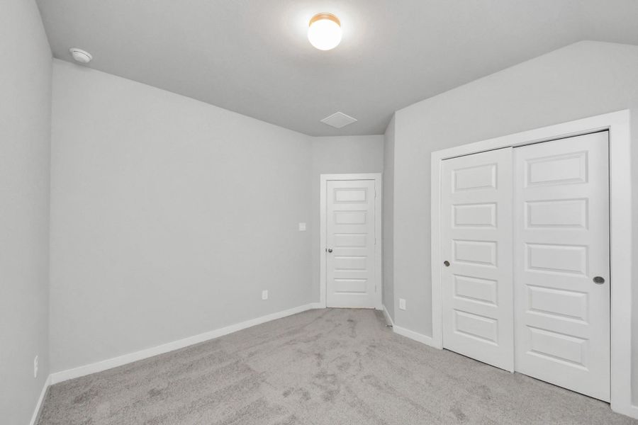 Generously sized secondary bedrooms featuring spacious closets, soft and inviting carpeting underfoot, large windows allowing plenty of natural light, and the added touch of privacy blinds for your personal retreat.