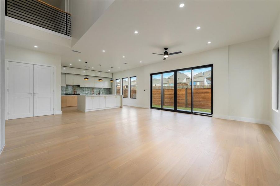Family room with recessed lighting, light wood-type flooring, and ceiling fan