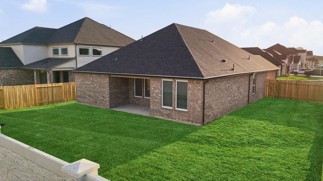 Large fenced-in backyard with a covered patio, perfect for outdoor entertaining. Large fenced-in backyard with a covered patio, perfect for outdoor entertaining.