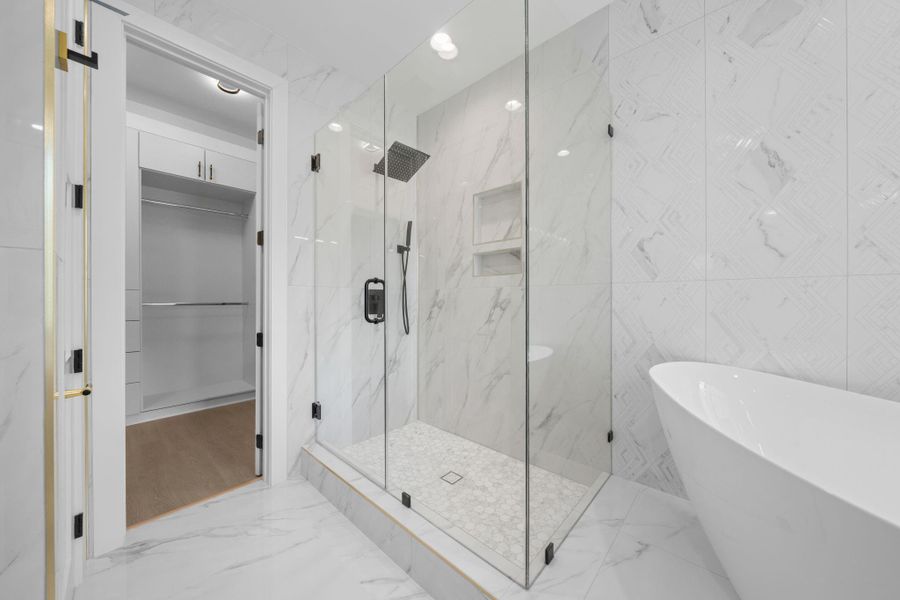 This bath is also highlighted by a glass enclosed shower. This bath is also highlighted by a glass enclosed shower.