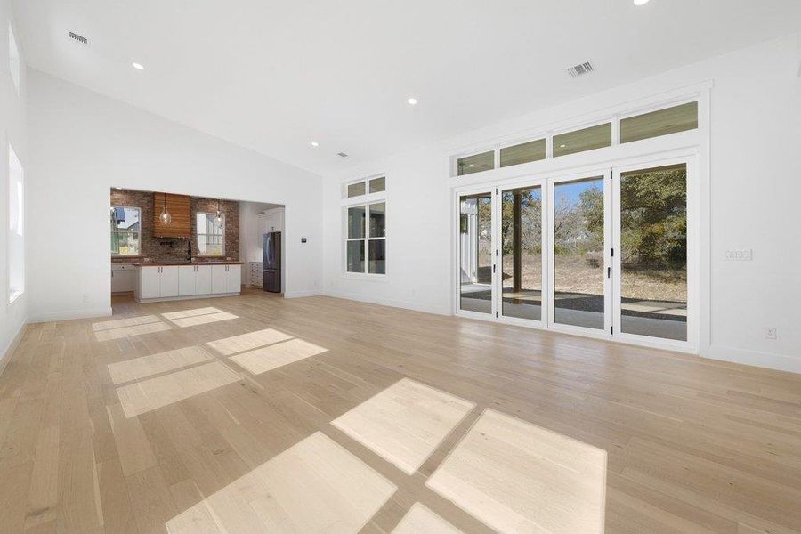Unfurnished living room with light wood finished floors and recessed lighting