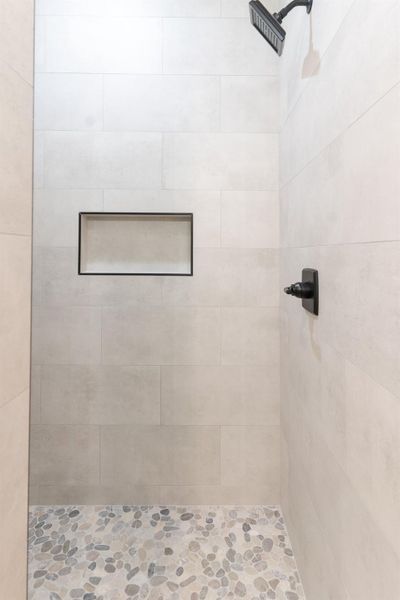 Full bathroom featuring tiled shower