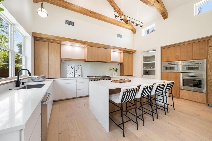 Kitchen featuring a center island, sink, light wood-type flooring, and stainless steel appliances