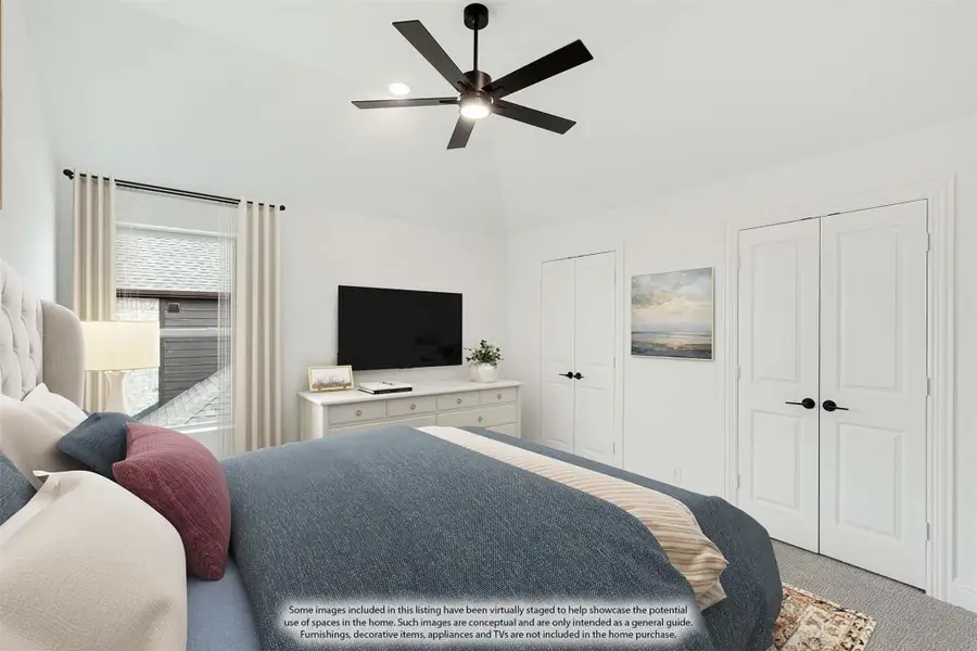 Bedroom with vaulted ceiling, black ceiling fan, two closets, and a dresser with TV