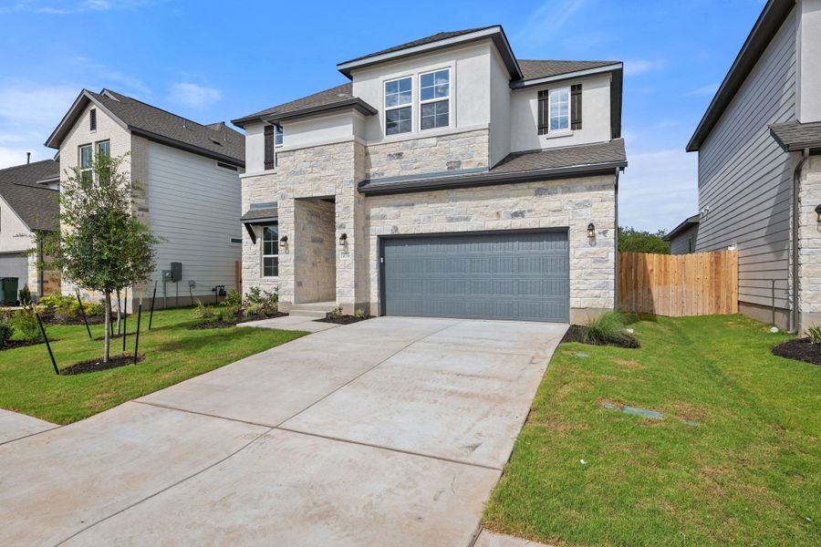Front exterior of a new home in Lagos Reserve, Manor, TX, highlighting curb appeal (Image 27). Front exterior of a new home in Lagos Reserve, Manor, TX, highlighting curb appeal (Image 27).