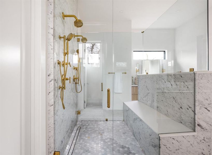 Full bath featuring a marble finish shower and tile patterned floors