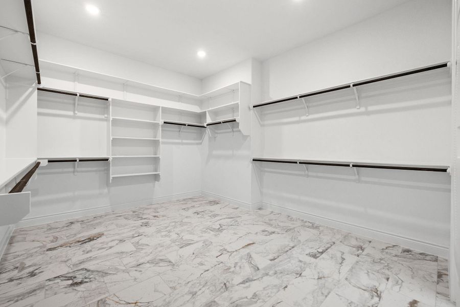 Walk in closet with marble finish floors