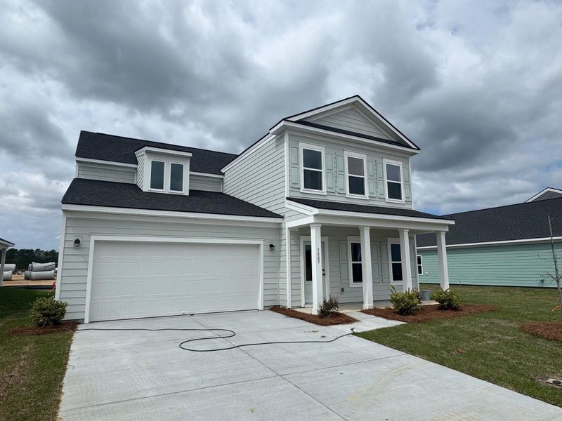 Front exterior of a new home in Tea Farm, Ravenel, SC, highlighting curb appeal (Image 23).