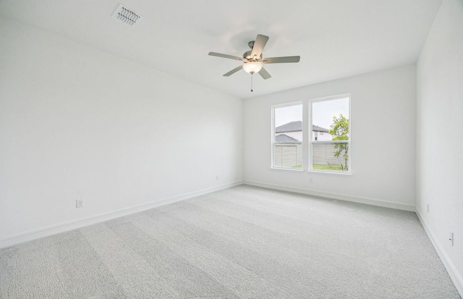 Spacious owner's suite bathed in natural light  *Real home pictured