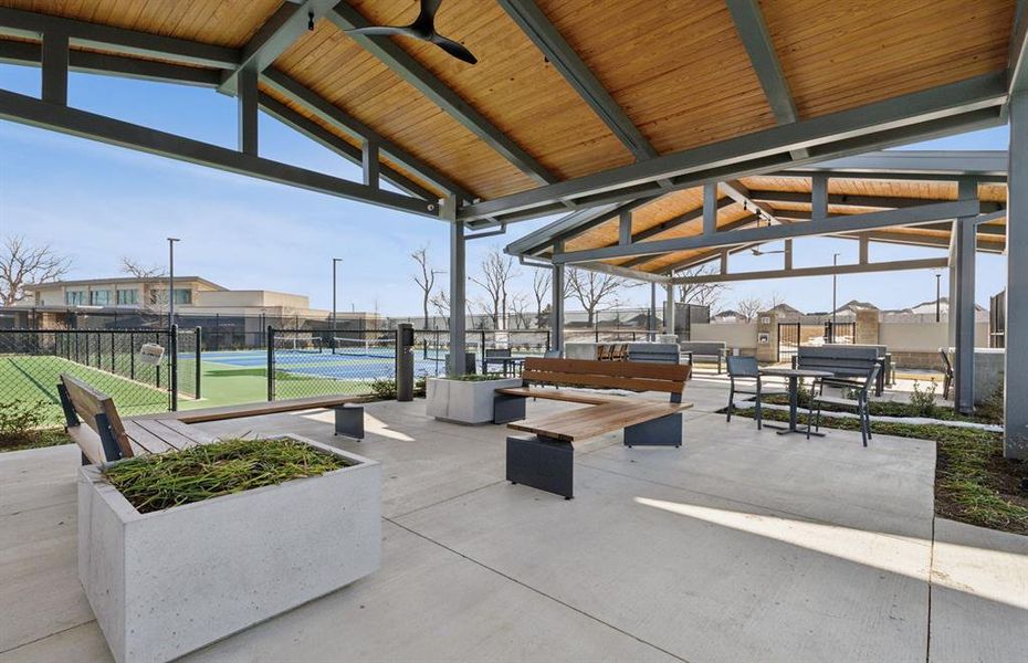 Community pickleball courts with shaded area in between.